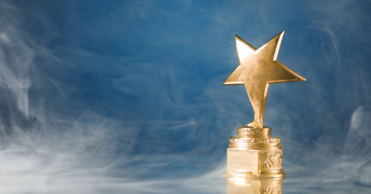 Golden Star award with blue smokey background